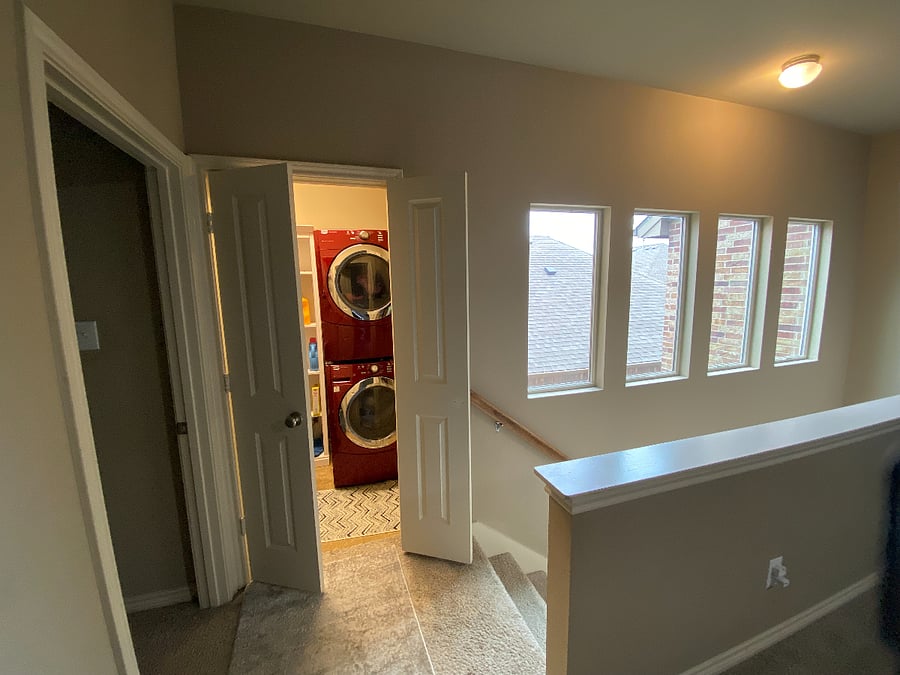 Stacked washer and dryer with hanger rods and shelves 