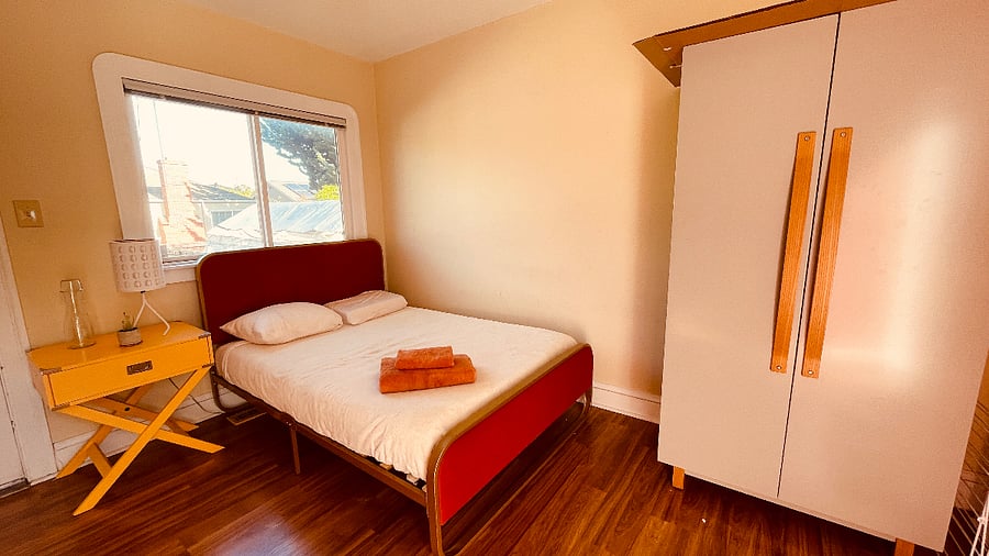 Empty wardrobe with hangers and shelves solely for guest use. Inside the wardrobe is also a foam roller, yoga mat and massage gun for guest use.

(To save room, your suitcase can be stored in the garage if desired.) 