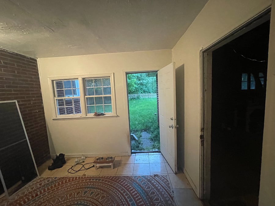 Private Mudroom providing access to fenced backyard, garage, and hall to enter home.