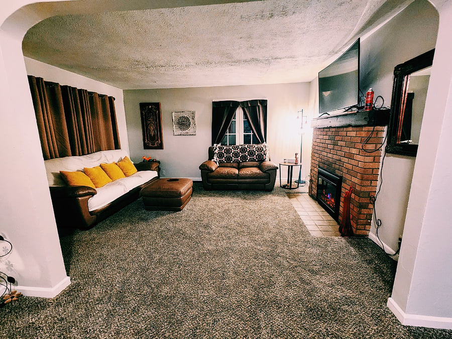 cozy living room with Samsung Curved smart tv, and fireplace.
