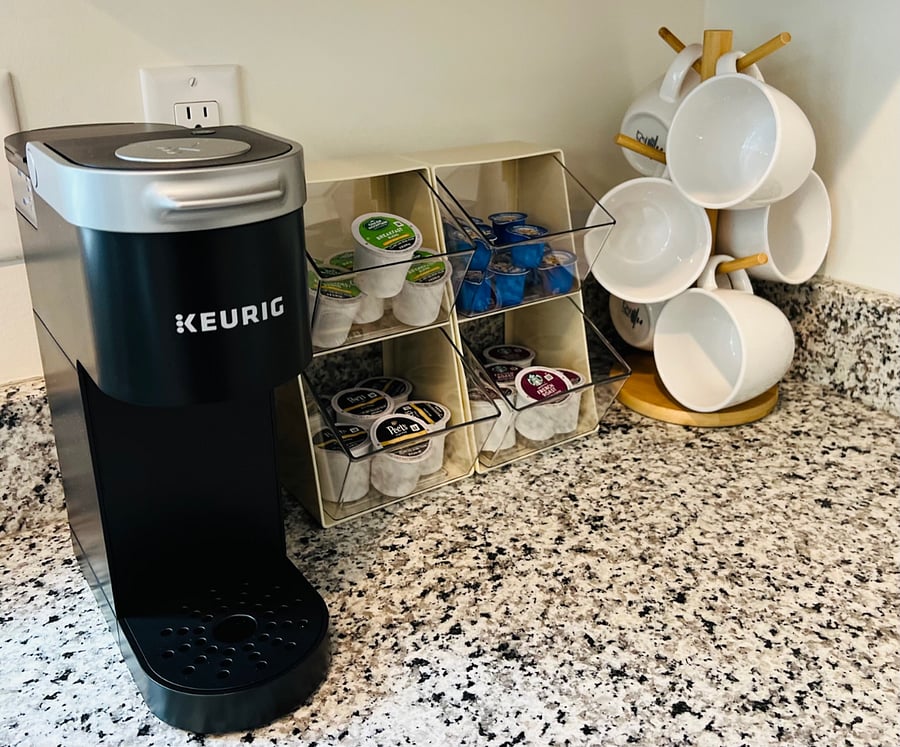 Coffee bar: mugs, coffee maker, Keurig single serve coffee maker, and k-pods