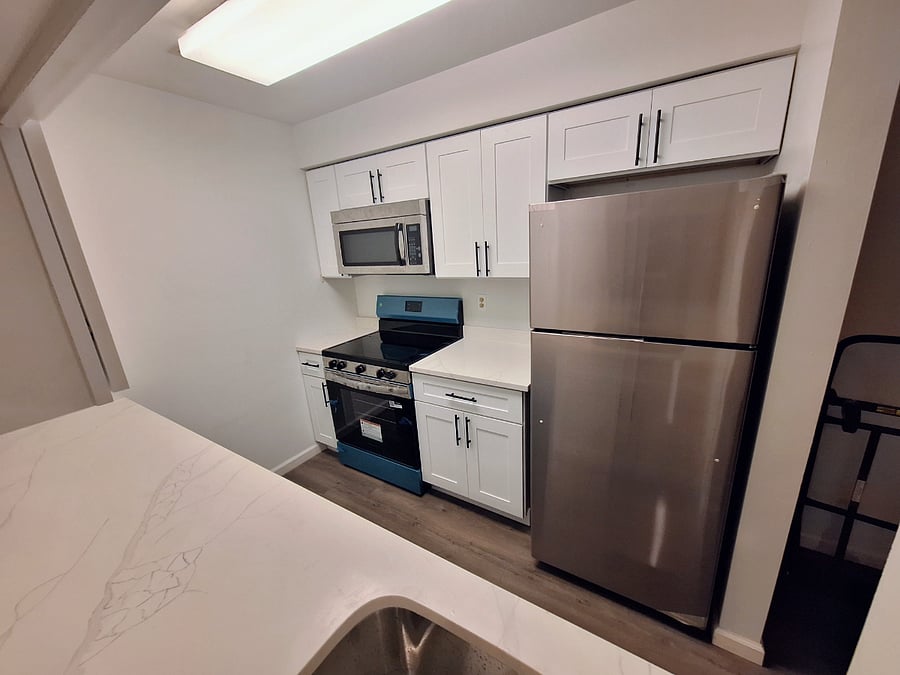 Kitchen w/ Stainless Steel Appliances & Quartz Countertops