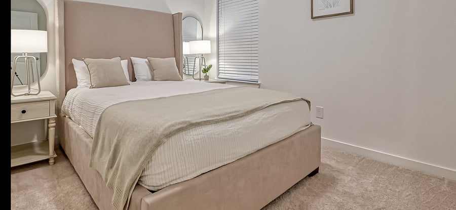 1st secondary bedroom with a queen size bed, walk-in closet and full bathroom access from the room.