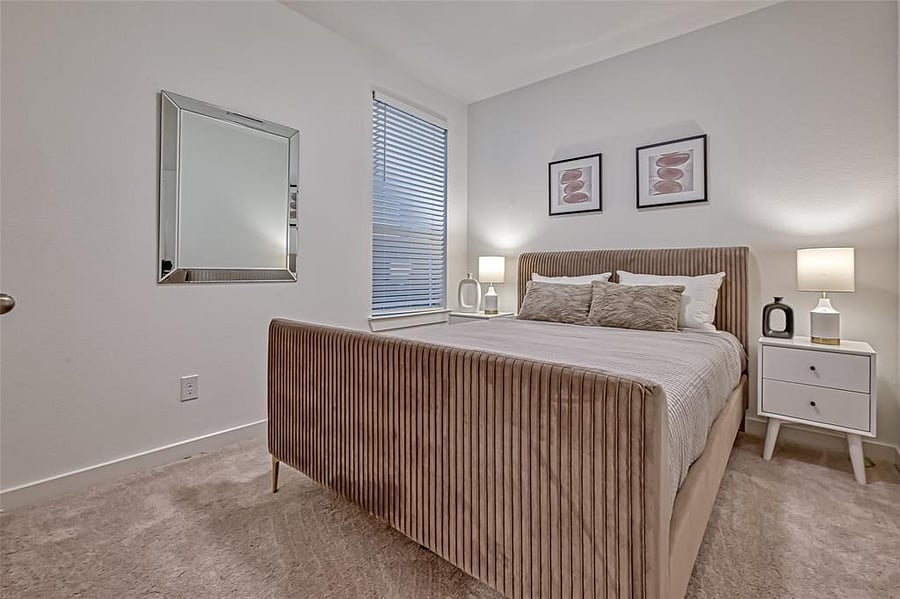 3rd secondary bedroom with a queen size bed and walk-in closet.