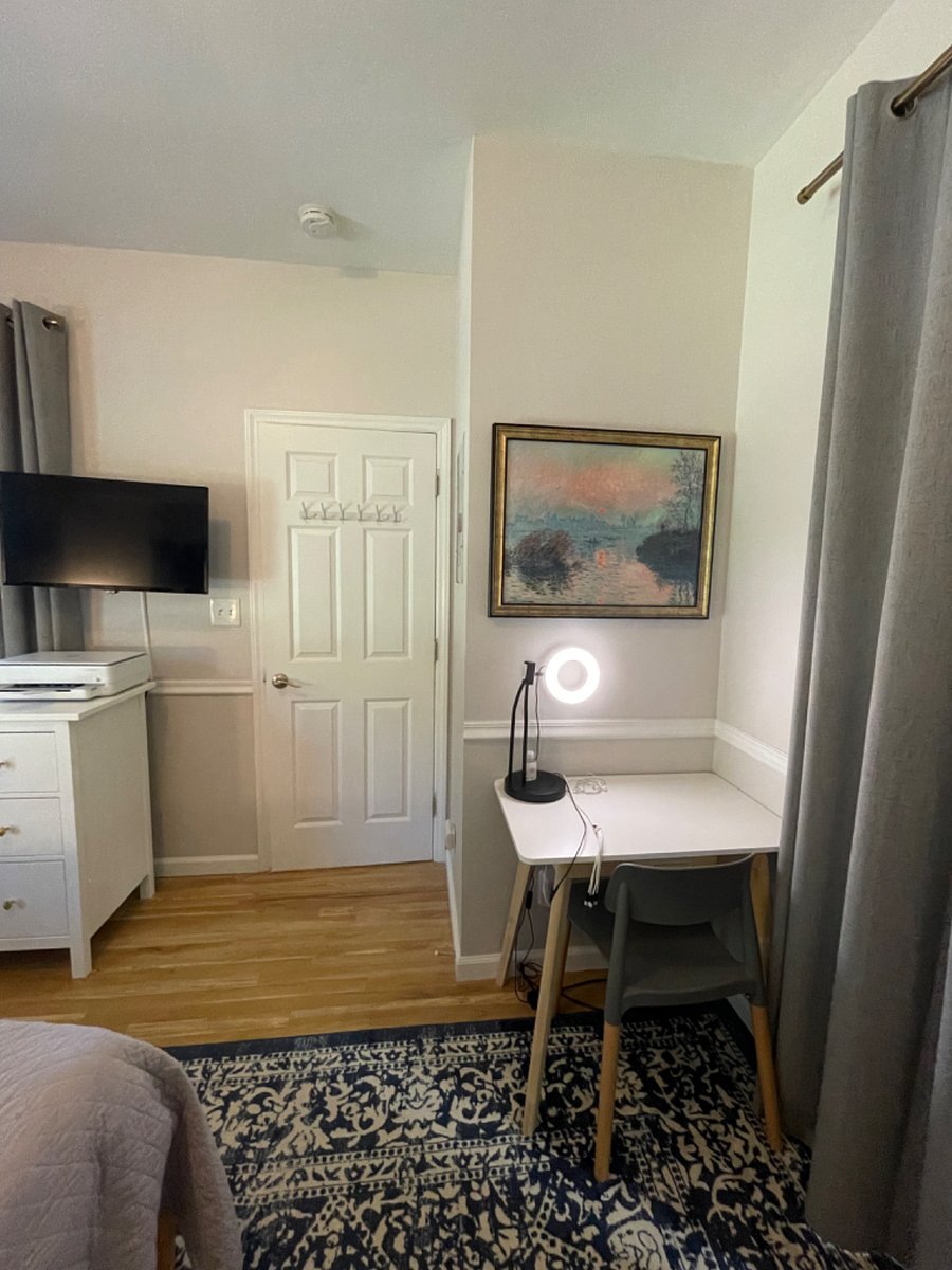 Primary bedroom with king bed, firm memory foam mattress, desk, sitting area, dresser, TV, walk-in closet, additional wall cabinet storage, and fully renovated (2024) ensuite bathroom