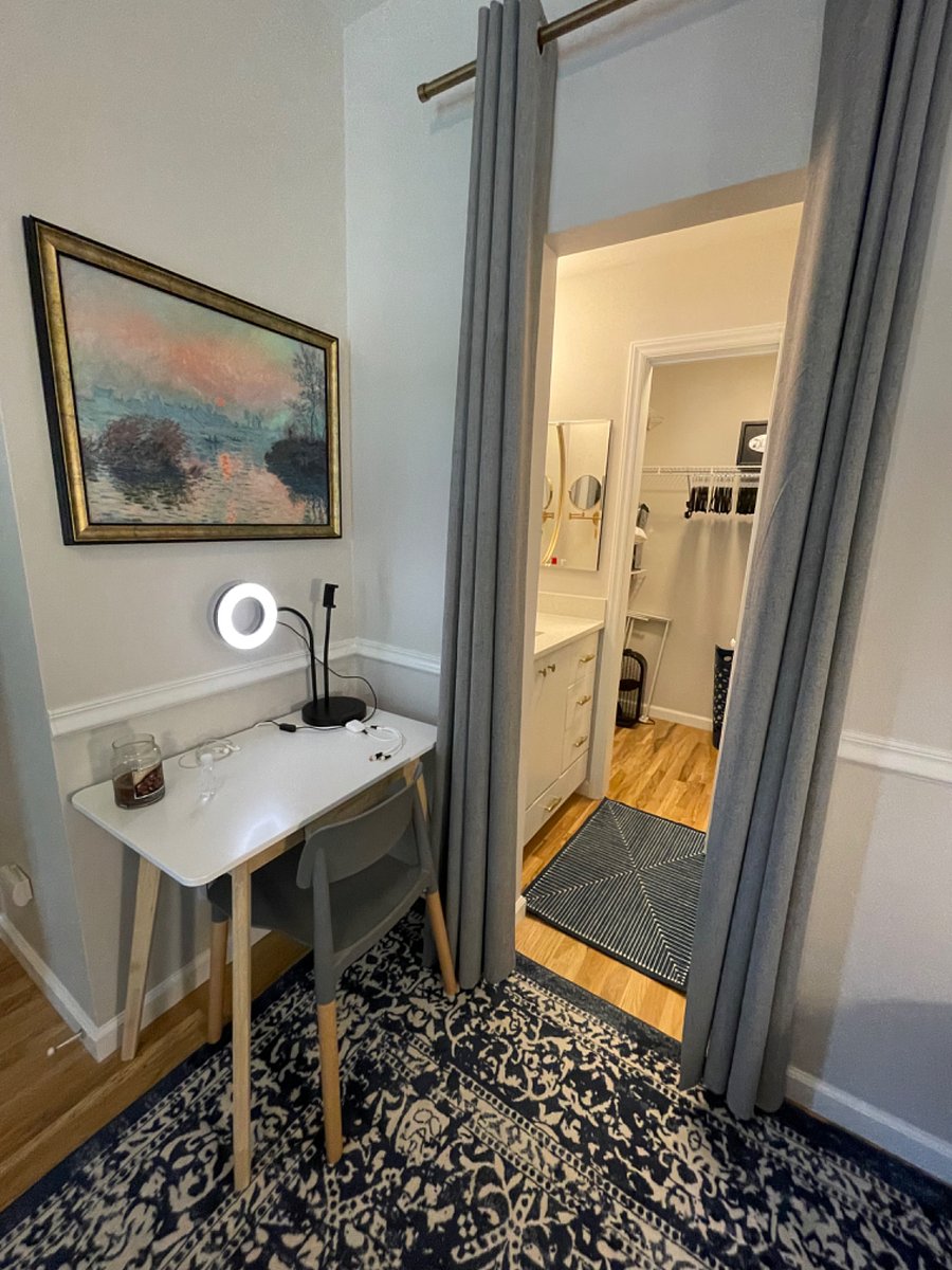 Primary bedroom with king bed, firm memory foam mattress, desk, sitting area, dresser, TV, walk-in closet, additional wall cabinet storage, and fully renovated (2024) ensuite bathroom