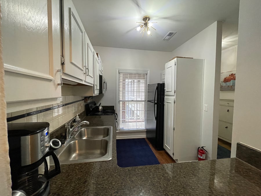 Full kitchen offers a dishwasher, full-size fridge, microwave, range, ample cabinet space, and is fully supplied with kitchenware, various appliances, and basic supplies