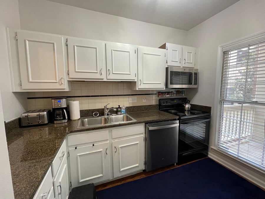 Full kitchen offers a dishwasher, full-size fridge, microwave, range, ample cabinet space, and is fully supplied with kitchenware, various appliances, and basic supplies