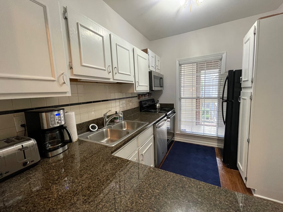 Full kitchen offers a dishwasher, full-size fridge, microwave, range, ample cabinet space, and is fully supplied with kitchenware, various appliances, and basic supplies