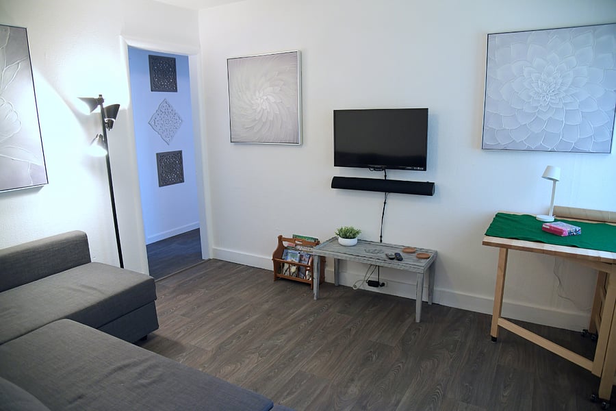 The table is on wheels and has two wings. It can be used as a work table with a chair from the kitchen.