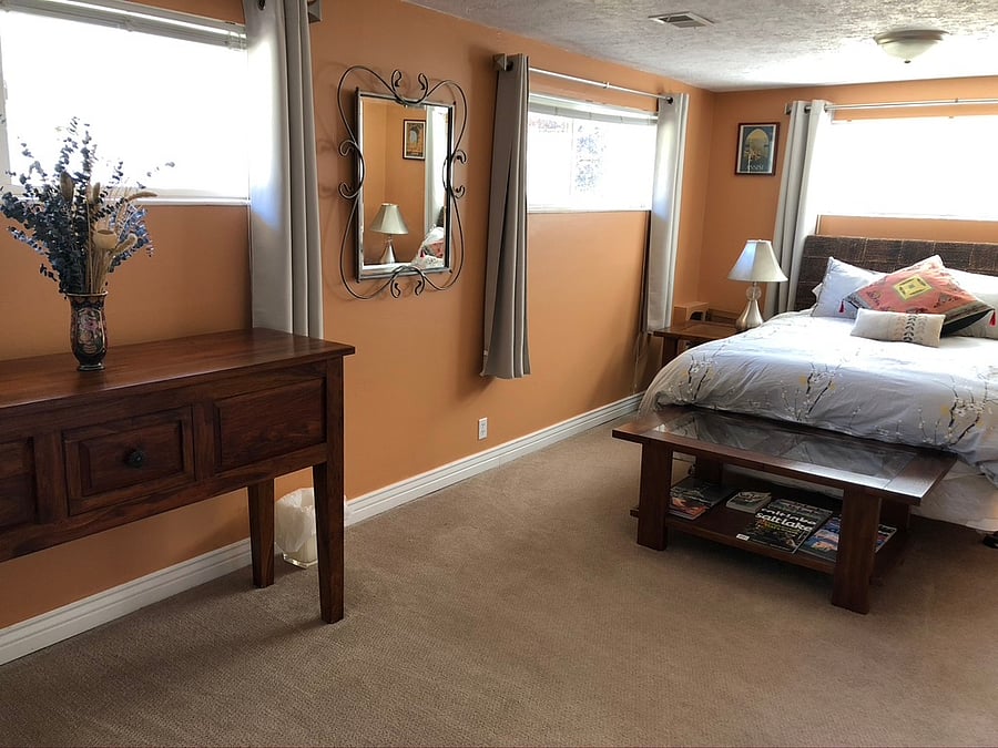Spacious bedroom with queen bed and blackout curtains