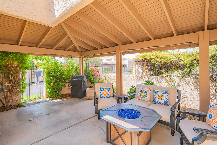 Covered patio with BBQ, fire pit and comfortable seating. We provide 2 propane tanks. 