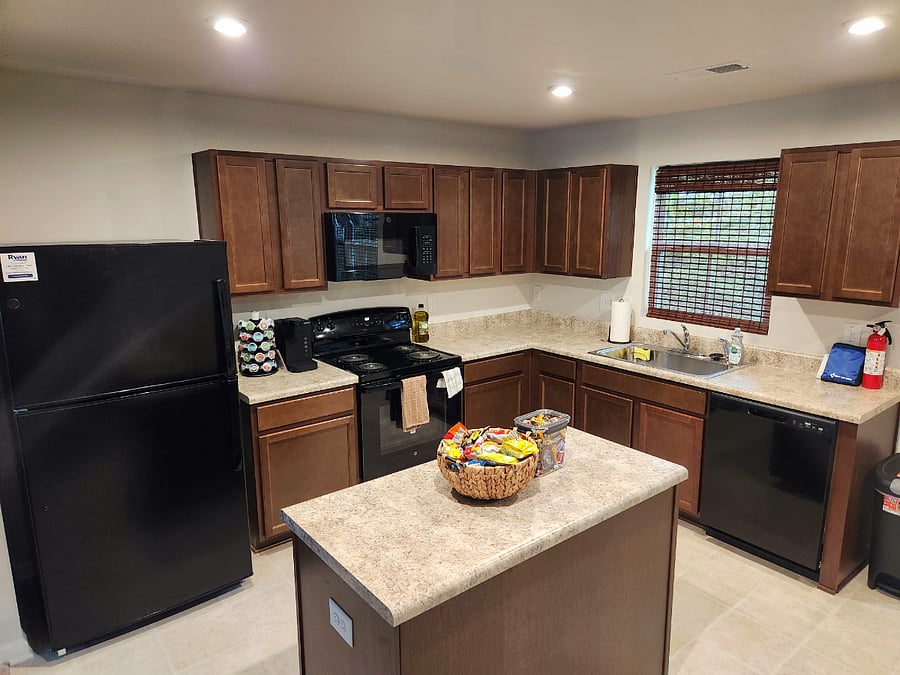 Full service kitchen equipped for all your daily needs with silverware, cookware, and several appliances.
