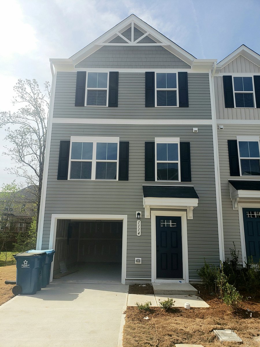 Front entrance view of the 3-story townhome .