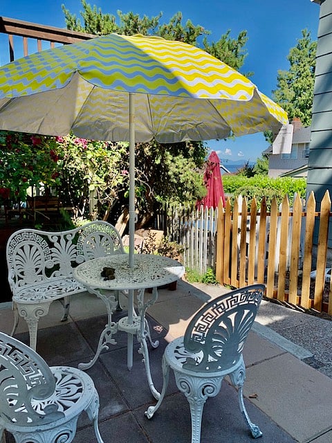 Private patio with vintage furniture and umbrella provided.