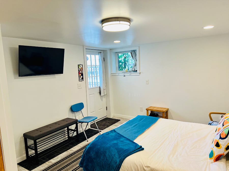 Front door into spacious bedroom/lounge. Black-out curtains, Queen size bed, 2 benches for luggage, 2 chairs, rocker, large closet, smart TV. Please remove shoes, indoor slippers provided to keep the floors bare-footable.