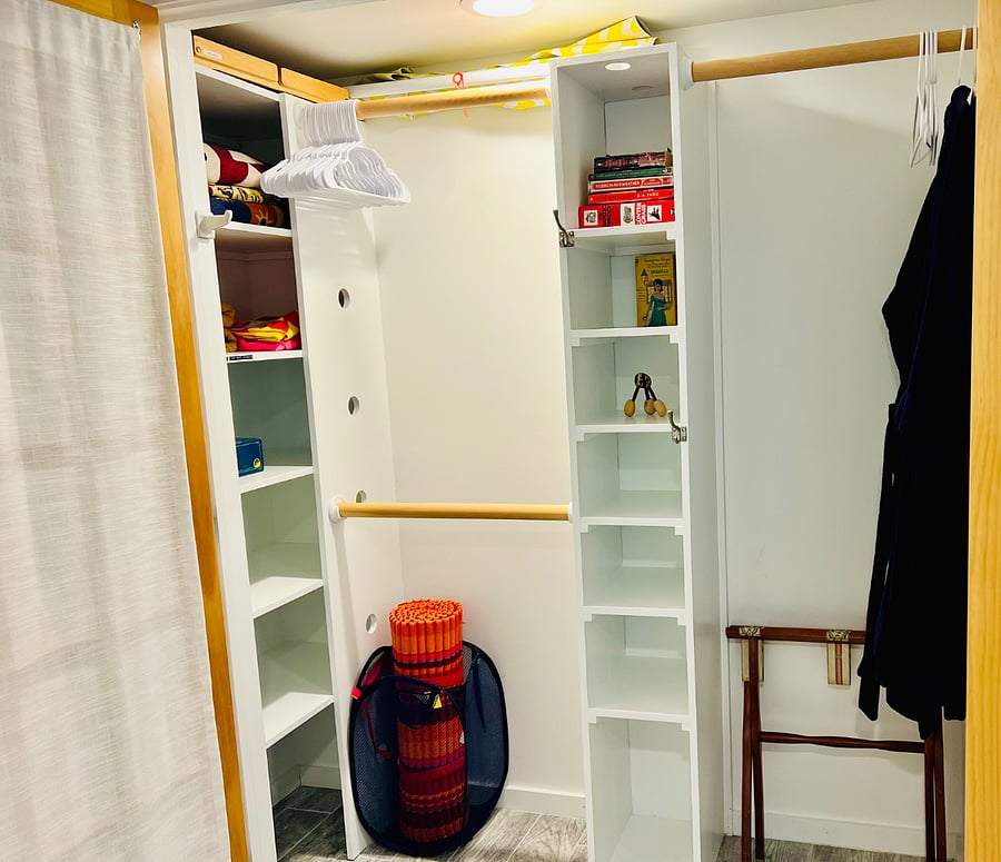 Large closet with robes, extra blankets, electric lap blanket, beach towels, patio umbrella, folding work table, books, games, hangers.