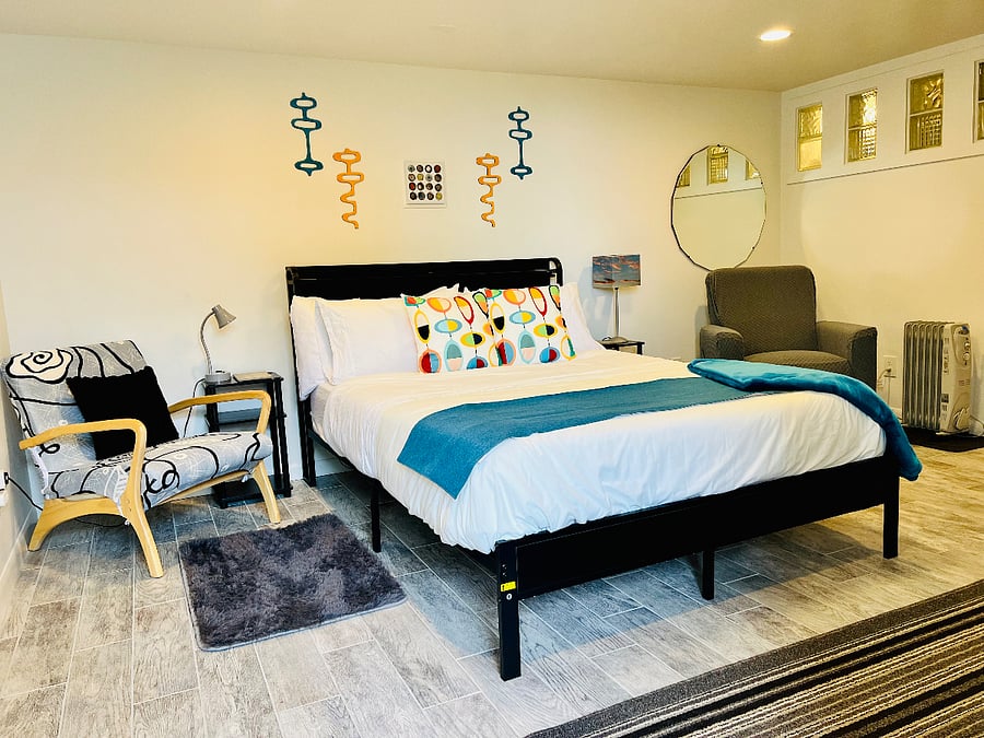 Spacious bedroom lounge with rocking chair. Queen size bed has mood lights. Light on timer, feel free to turn off at bedside or unplug from timer.