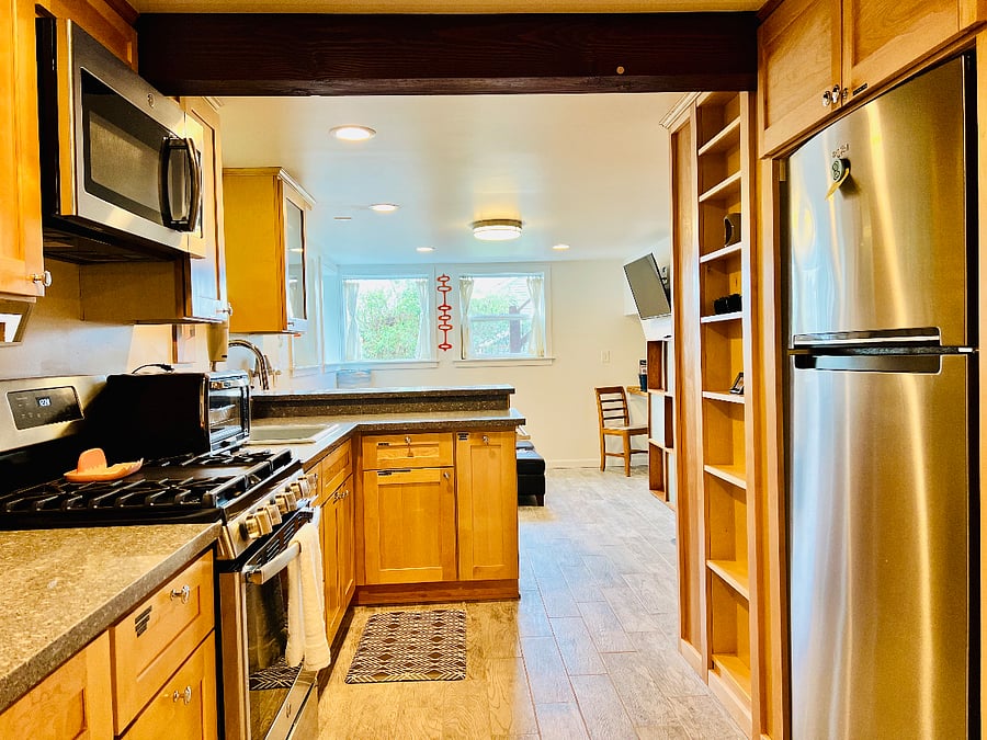 View through kitchen into living room. Chefs delight kitchen.