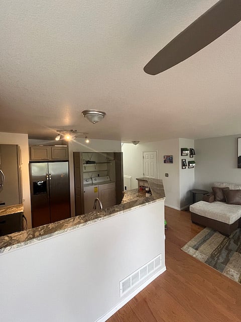 Washer/dryer in the main living area and kitchen