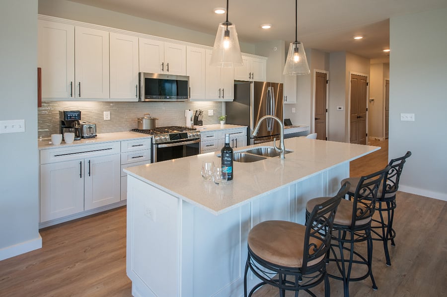Fully equipped kitchen with seating for three at the island. 