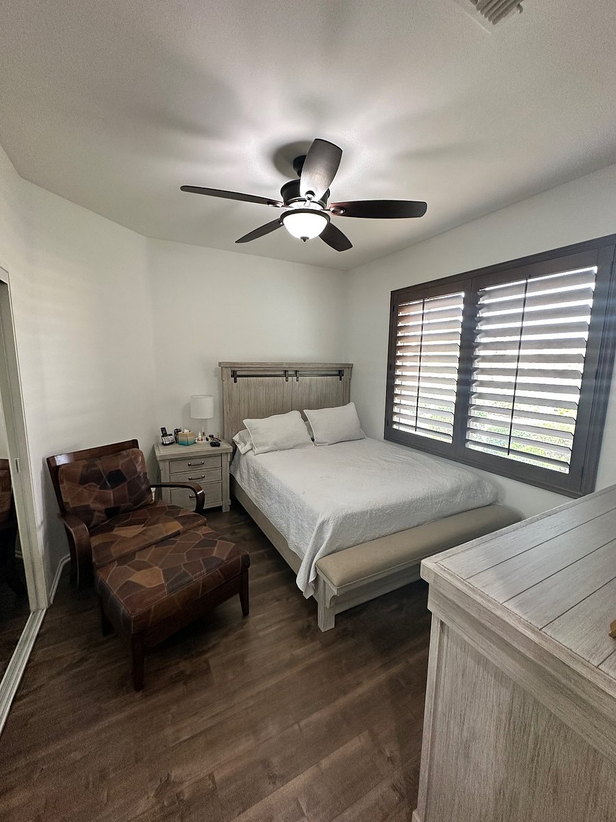 Guest room with sitting chair and wall mounted 55' LCD TV.