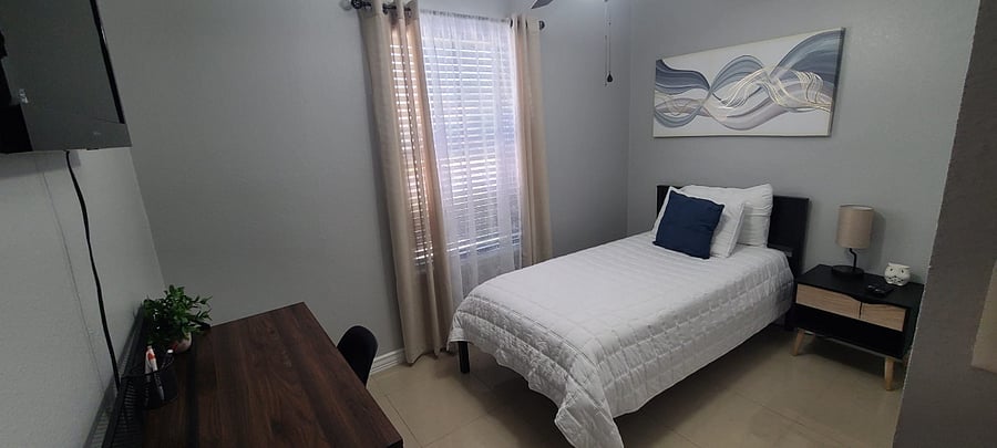 Bedroom 1 with twin size bed and workstation