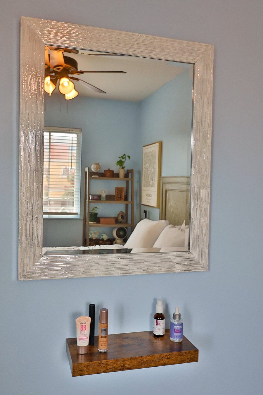 Large mirror and a shelf below for beauty/personal products.