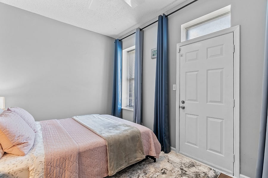 1st bedroom with queen bed and 100% black out curtains.