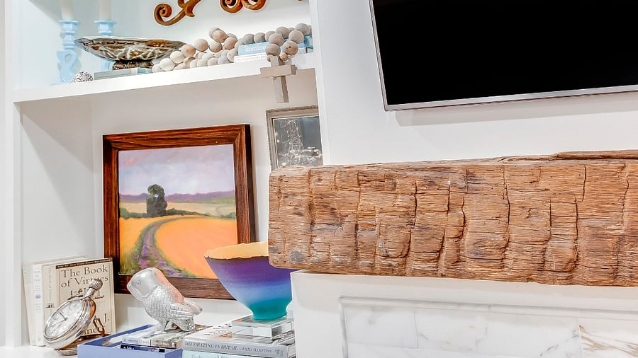 A fireplace mantle made from Hand Hewn Tobacco Barn wood.