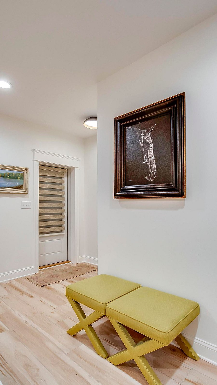 Jonathan Adler X benches provide extra seating with a gorgeous painting of a thoroughbred horse above