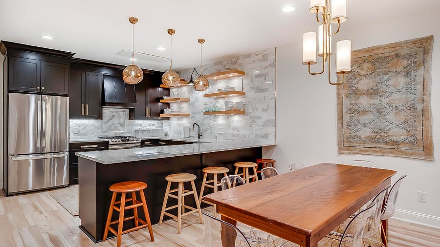 Gorgeous gold Tom Dixon Melt Pendants accentuate a large Quartz Peninsula. Perfectly sized counter stools make it so comfortable to use.