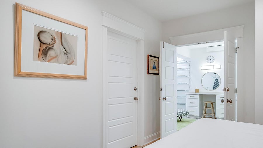 A large walk in closet with an extra vanity area for added convenience