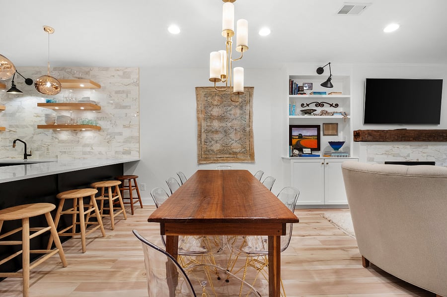 A custom made farmhouse table accentuated with a Kate Spade chandelier with seating for 8 give an intimate feel for a dining experience.