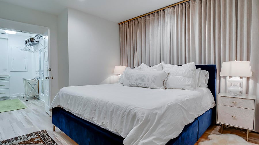 Easy access to a large closet with convenient nightstands for lots of storage. Right behind the curtains is a window well provided for your safety.