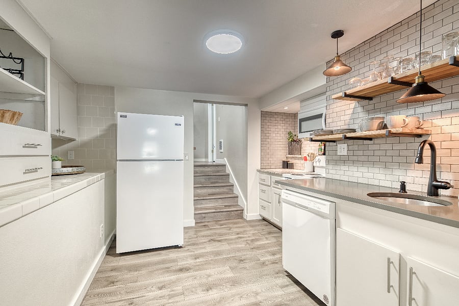 The galley kitchen easily allows for multiple cooks and the countertop next to the fridge allows a space for your groceries as you put them away.