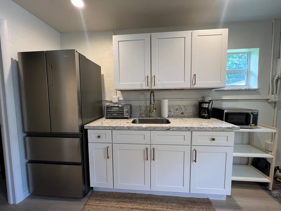 kitchenette with full size fridge and freezer, toaster, coffee maker, microwave, electric 2 burner countertop,