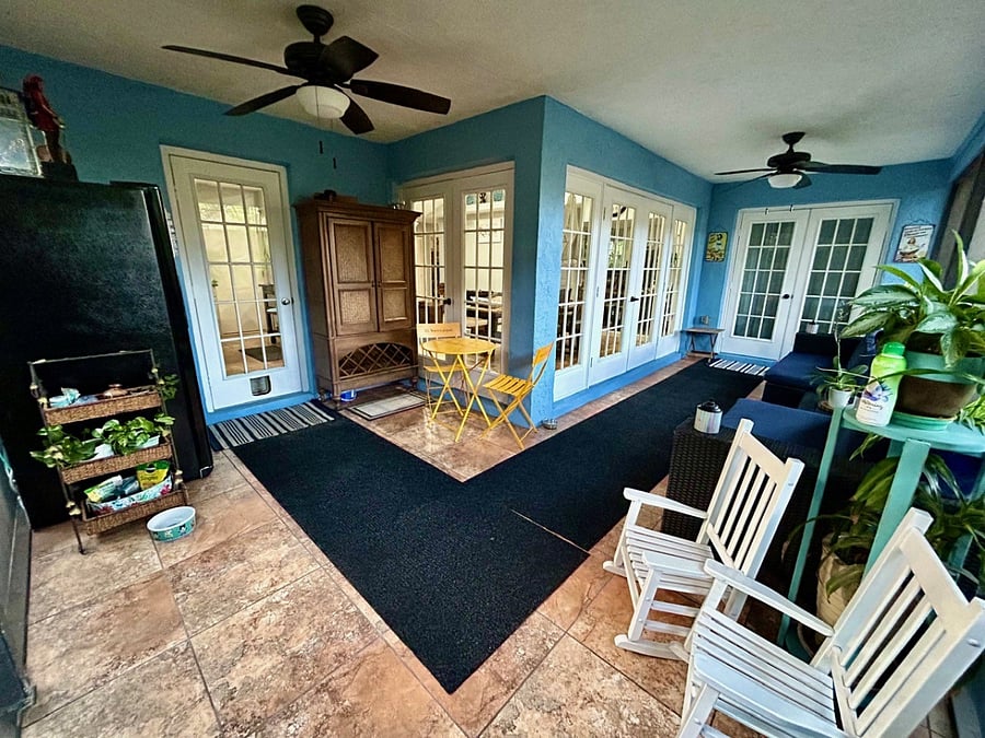 Screened in porch with ceiling fans and lighting