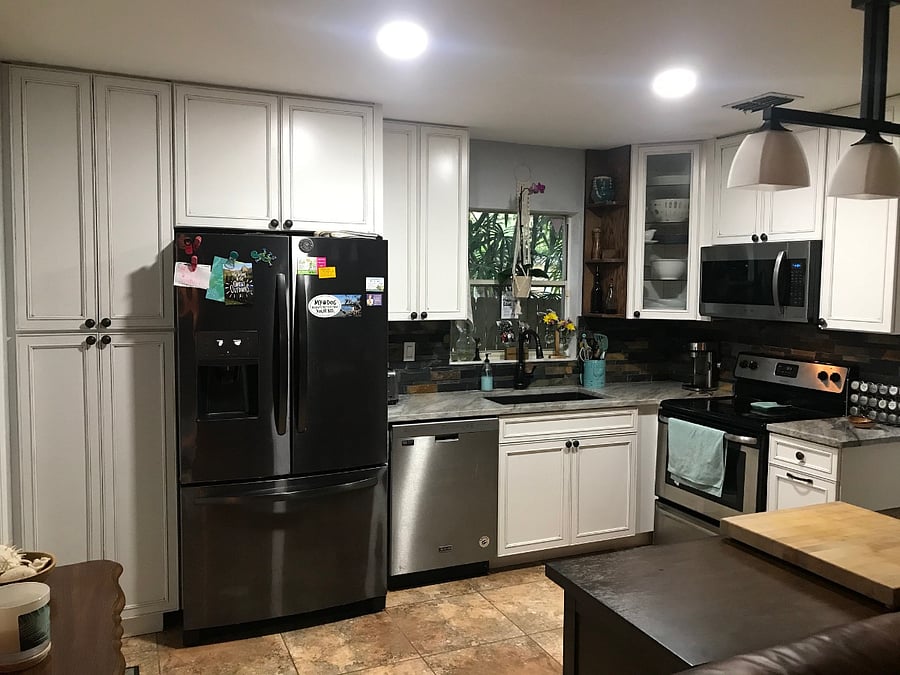 Full open concept kitchen overlooking living and dining room spaces
