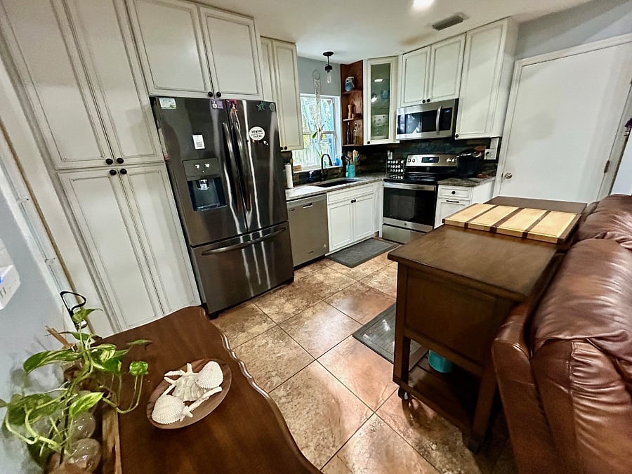 Full open concept kitchen overlooking living and dining room spaces