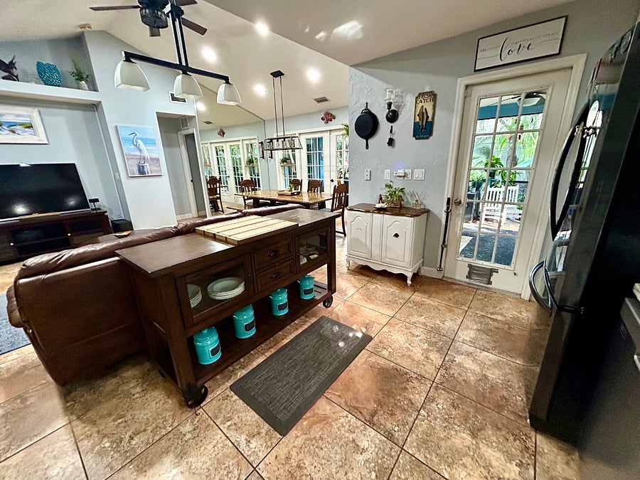 Kitchen island overlooking living and dining room spaces. Watch TV while cooking!