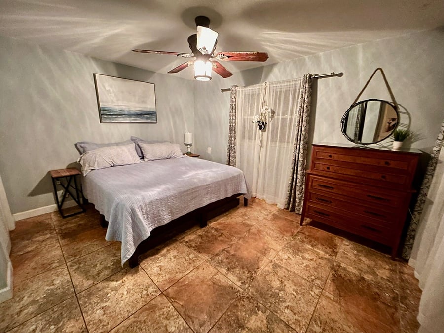 Master bedroom with comfortable king bed.