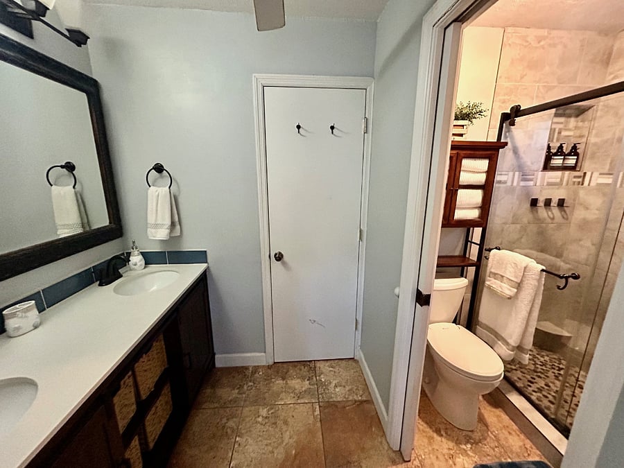 Master bath with double vanity that separates from shower/toilet room.