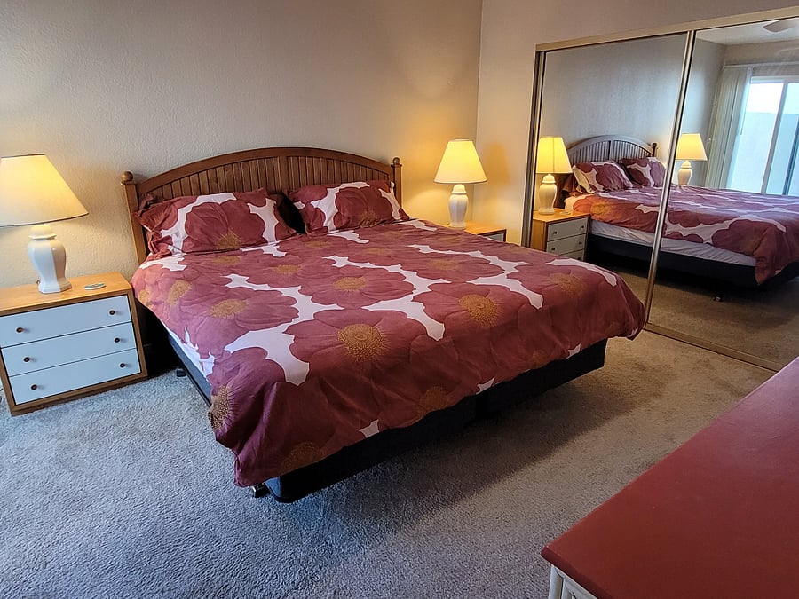 Primary bedroom with new king bed, two dressers, and nightstands