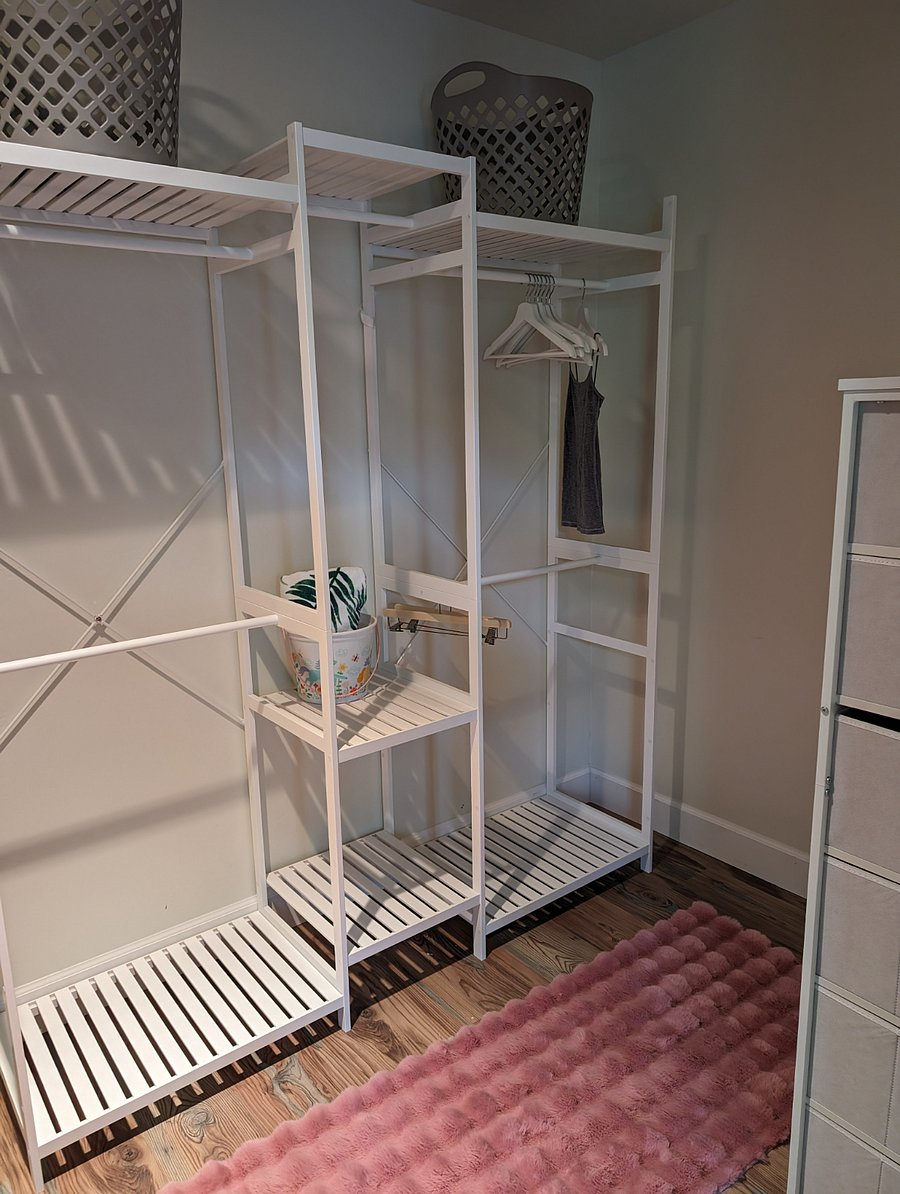 Spacious walk in closet with full length mirror and dresser