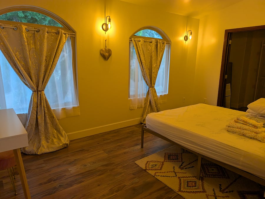 Bedroom includes queen size bed and vanity