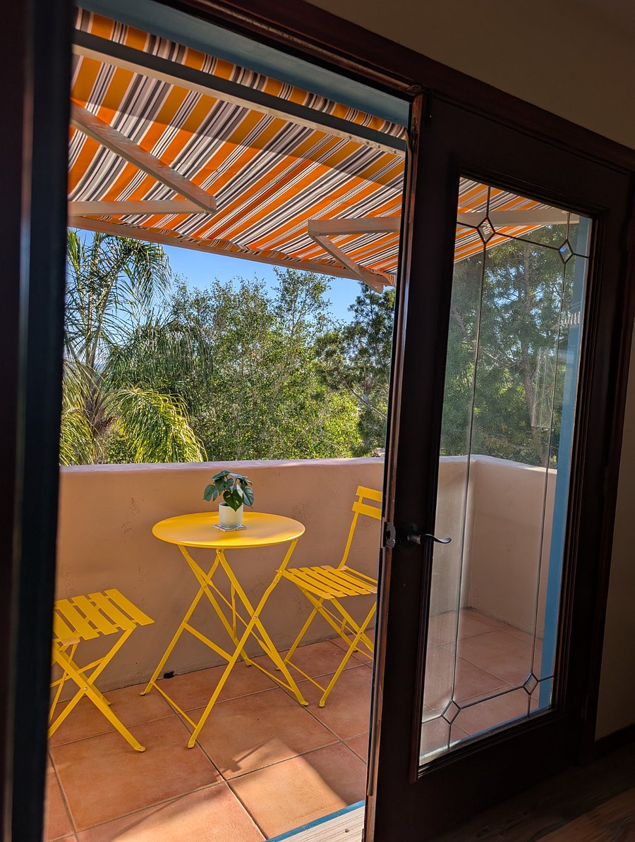 Covered patio with table and chairs to enjoy the sunset