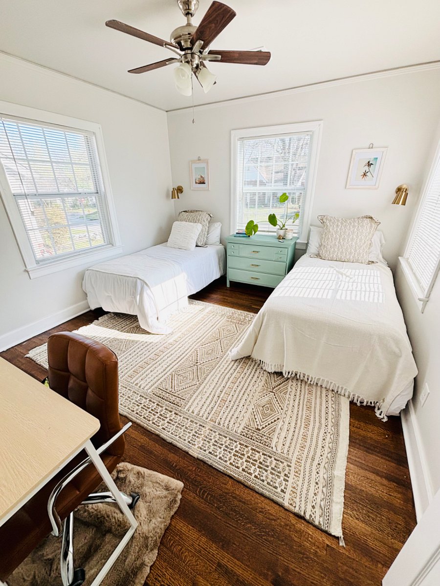 Guest bedroom with 2 twin beds, desk and chair, dresser O