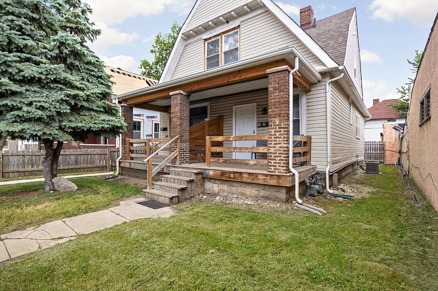 A charming home with a cozy front porch and a spacious yardperfect for relaxing and entertaining!