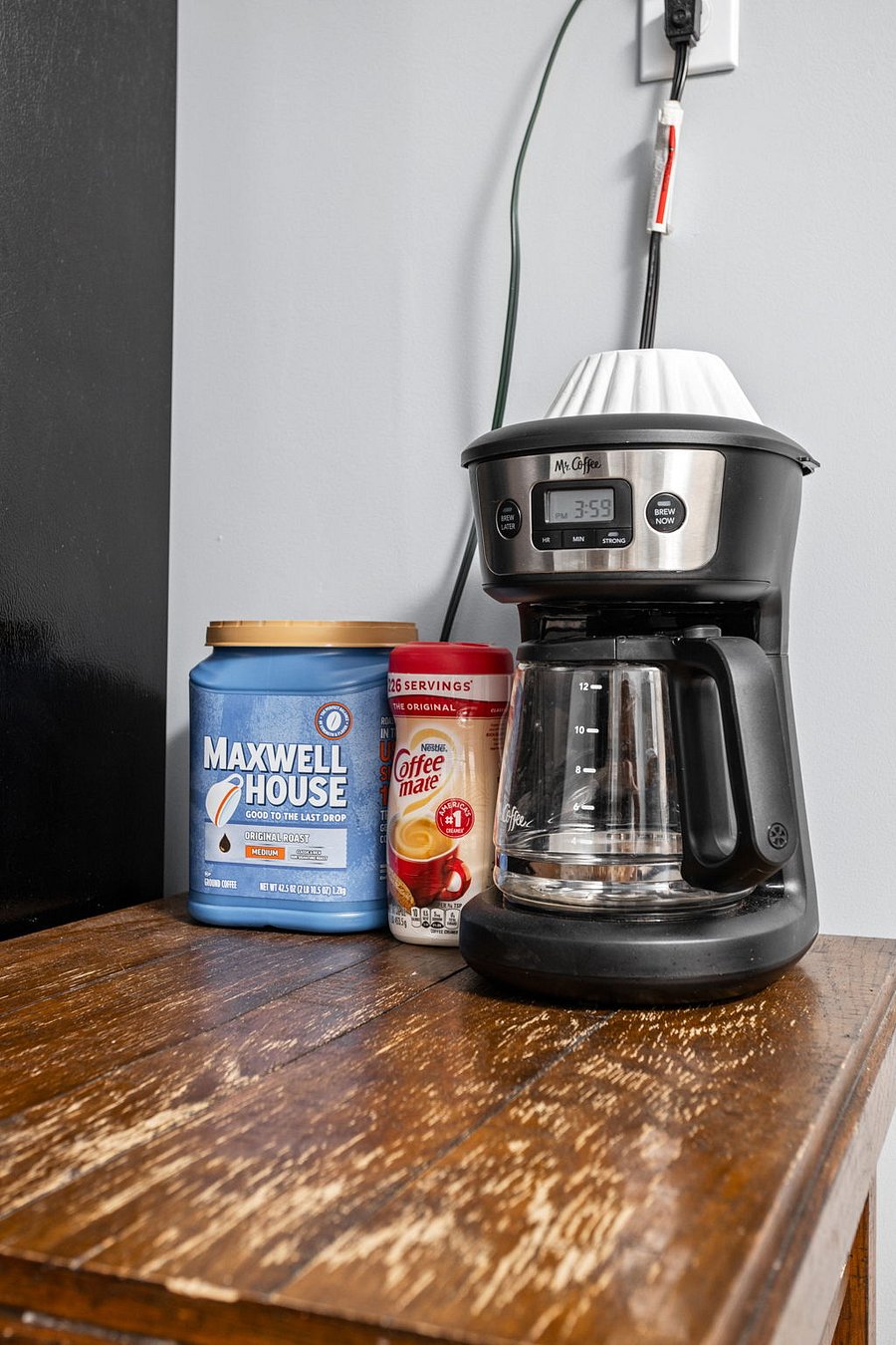 A Coffee station set up with a classic drip coffee maker, Maxwell House coffee, and Coffee-mate creamer for a perfect morning brew.